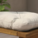 IKEA KUDDARNA light grey-beige outdoor cushion placed on a garden chair balcony setting