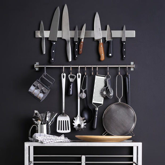 IKEA KUNGSFORS wall rail with knives, utensils and accessories organised on dark background