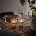 IKEA KUNGSTÄRNA clear glass and gold-colour tealight holder, alternate angle on plain background