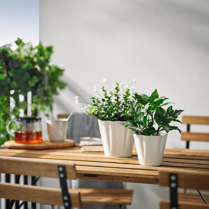  IKEA KVASTSPIREA off-white plant pot styled on wooden table with green plant traditional home decor