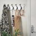 Minimalist white IKEA LANDKRABBA rack with hooks, showcasing a simple and functional storage solution.-40531839