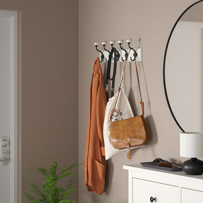 A sleek and functional wall-mounted hook rack for organizing coats and bags