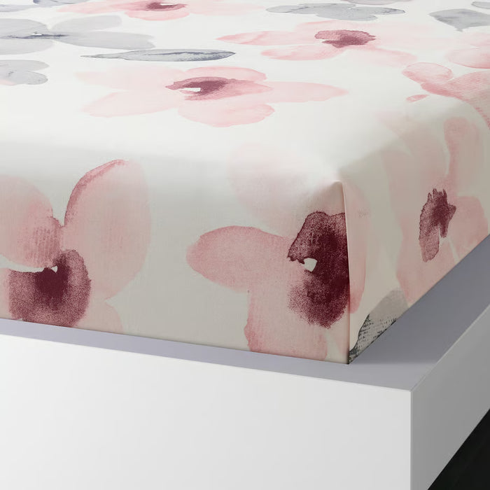 IKEA LAPPNYCKLAR floral bed linen set on white bed in bright bedroom with large window and sheer curtains