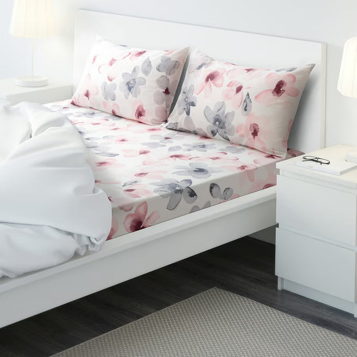 IKEA LAPPNYCKLAR multicolour floral bed linen set styled on white bed with white comforter and bedside lamp