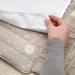  Close-up of a hand folding the IKEA LEN changing mat showing the polka dot cotton cover