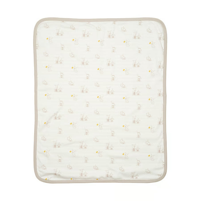 IKEA LEN white beige baby blanket laid next to newborn accessories in nursery