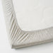 IKEA LENAST fitted sheet on baby cot mattress showing elastic edges

