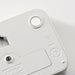  Close-up of IKEA LJUNGPIPARE white digital clock showing round buttons and display symbols