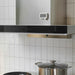  IKEA LJUNGPIPARE white magnetic digital clock mounted on kitchen fridge beside large cooking pot