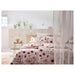 IKEA LÖNNHÖSTMAL duvet cover set displayed on a bed, highlighting the bright floral pattern and cozy fabric-30547032