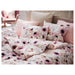 IKEA LÖNNHÖSTMAL duvet cover on a bed, nature-inspired multicolor pattern-30547032