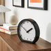 IKEA LÖVGRODA black wall clock mounted on light wall modern living room