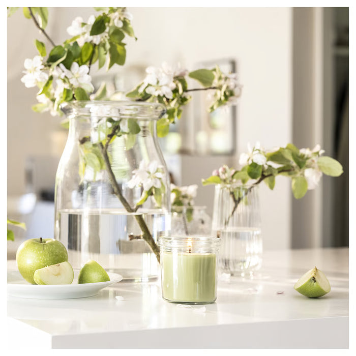IKEA LÖVSKOGSLUND candle on kitchen counter with white flowers and green apples