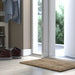 IKEA LOHALS jute door mat placed outside white entrance door with greenery