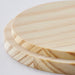 Close-up of IKEA LOTSFÅGEL pine candle lid showing natural wood grain