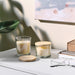 IKEA LOTSFÅGEL pine lid for scented candle placed on a glass candle