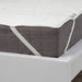  IKEA LUDDROS white mattress protector with elastic corner straps secured on bed frame close-up