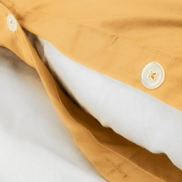 Close-up of the soft fabric texture of the IKEA LUKTJASMIN duvet cover in yellow- 00541135