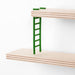 Close-up of IKEA LUSTIGT green plastic mini ladder resting on birch plywood shelf panel