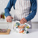  Person using IKEA MÄRKBART scissors to cut open a bag in a kitchen while holding glass containers