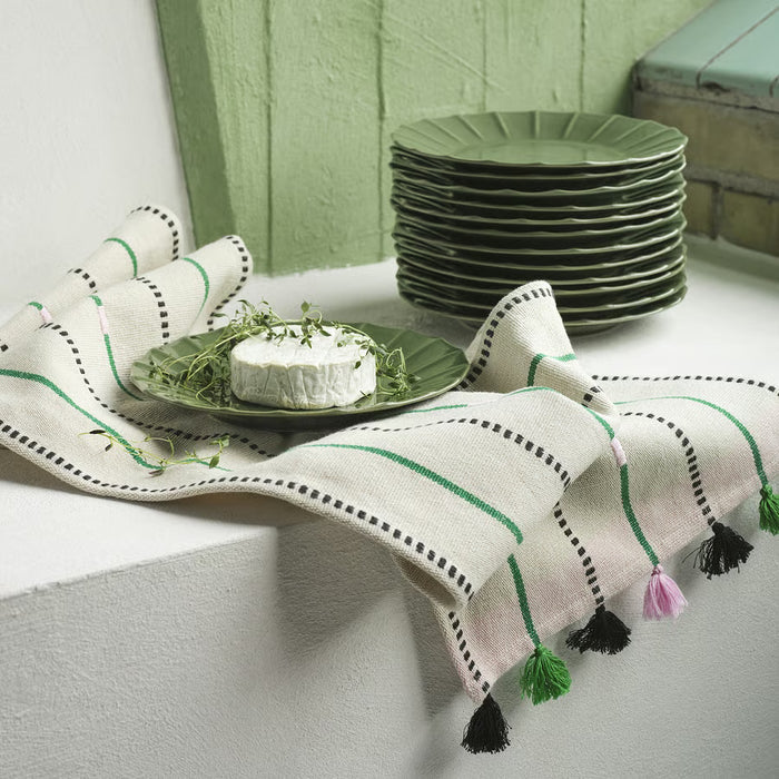 IKEA MÄVINN green stoneware plate on striped tasseled cloth with stacked plates