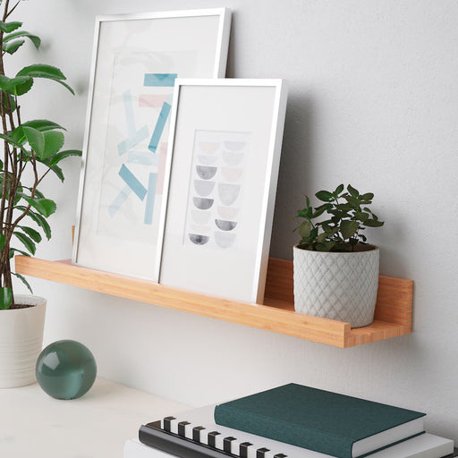 Bamboo picture ledge by IKEA with artwork and decor on a wall-20511359