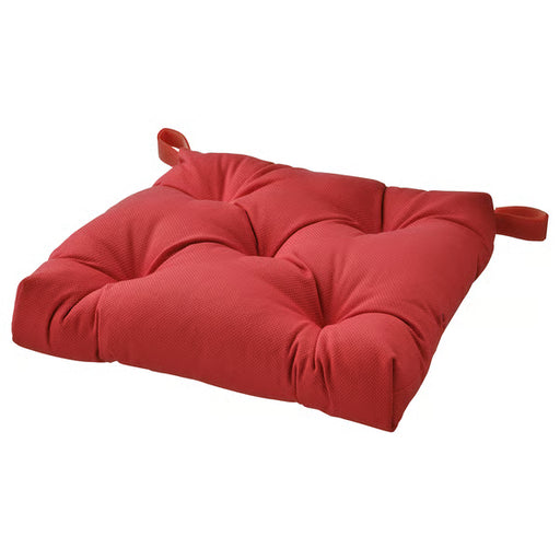 Red cushion with ties on a white background