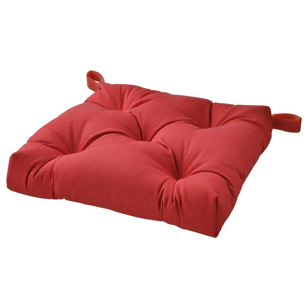 Red cushion with ties on a white background
