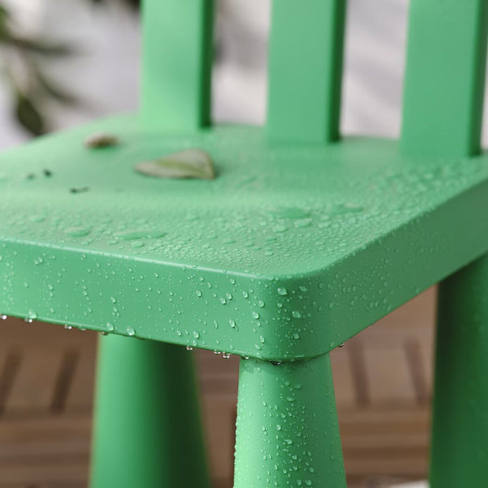 Green children's chair from IKEA MAMMUT series, ideal for in/outdoor play