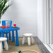 IKEA MAMMUT white stool in kids play area with blue table colourful stools and cups on grey rug