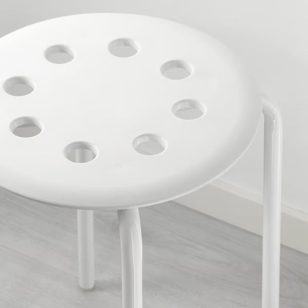 Close-up of IKEA MARIUS white stool round perforated seat and powder-coated leg detail