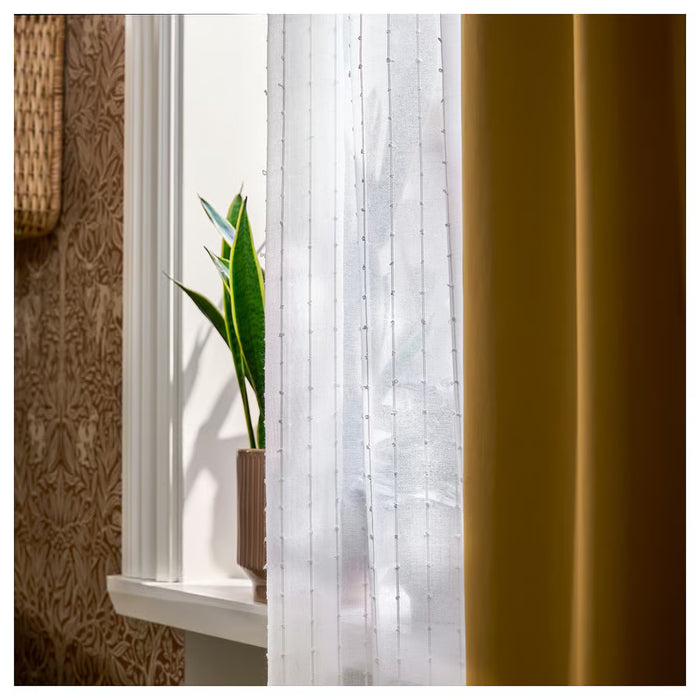 IKEA MATILDA sheer curtains paired with room darkening curtains on window