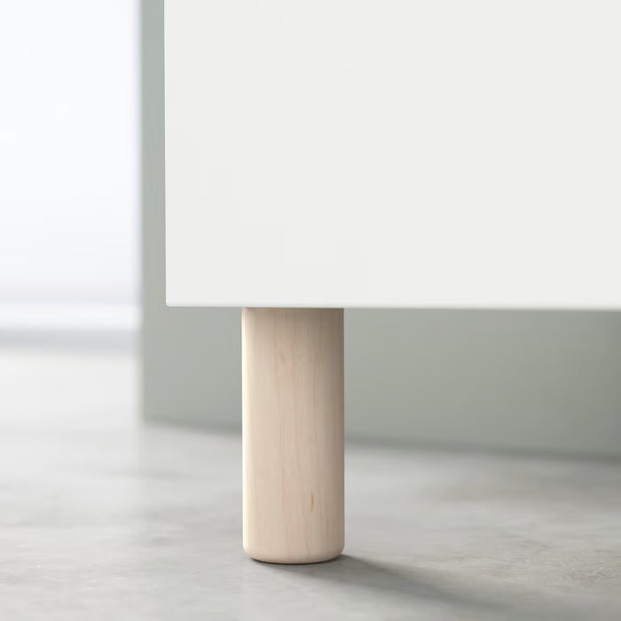Single IKEA MEJARP birch leg supporting a white BESTÅ furniture combination side view
