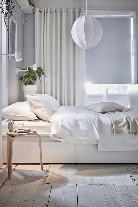 IKEA MERETE white cotton curtains styled in a minimal bedroom with white bedding and pendant light