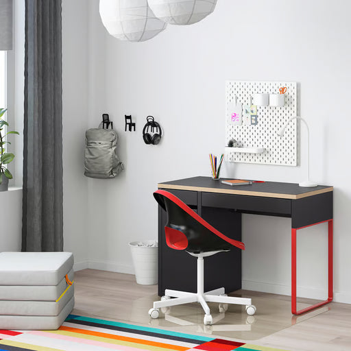 IKEA MICKE anthracite red desk in modern home study setup with red chair and pegboard wall organiser