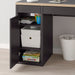 IKEA MICKE desk cabinet open showing internal adjustable shelf with storage bins and books