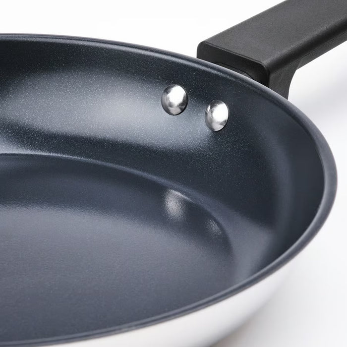 Close-up of IKEA MIDDAGSMAT frying pan showing smooth non-stick interior and sturdy handle