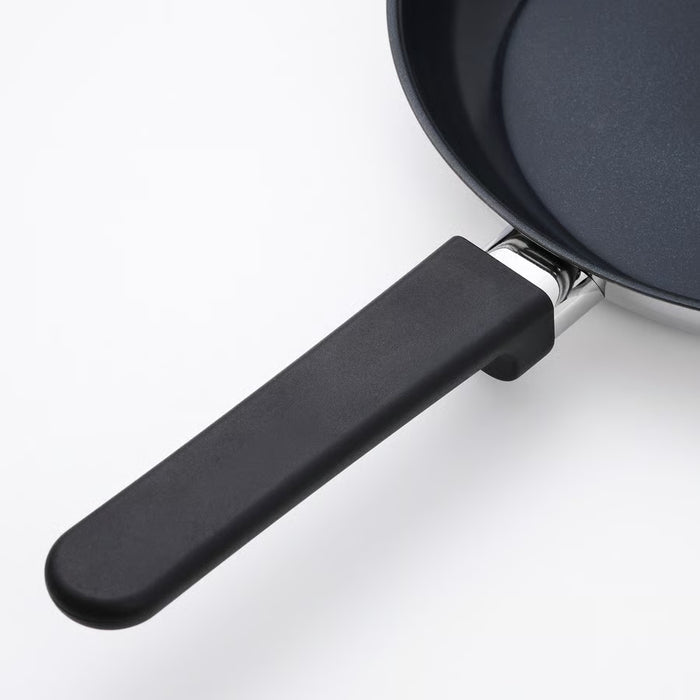 IKEA MIDDAGSMAT frying pan with ergonomic phenolic plastic handle on white surface