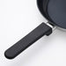 IKEA MIDDAGSMAT frying pan with ergonomic phenolic plastic handle on white surface