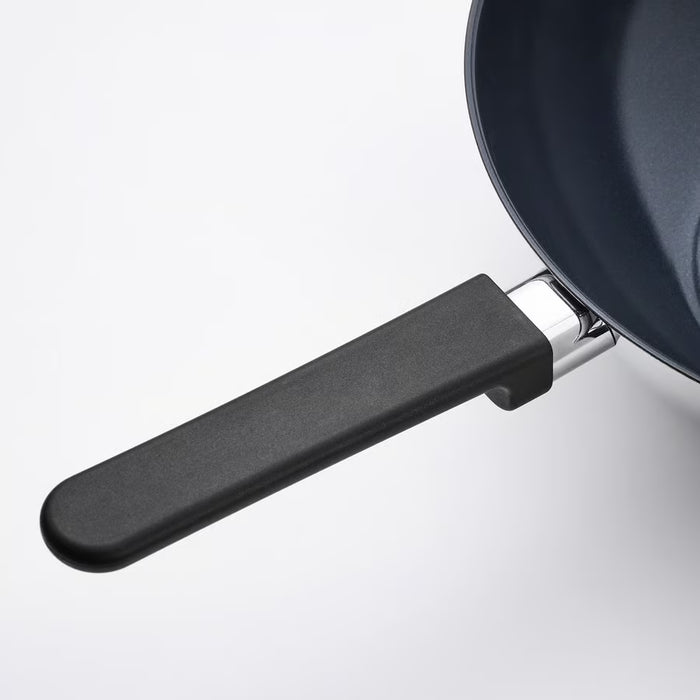 Close-up of IKEA MIDDAGSMAT wok non-stick interior and sturdy handle