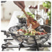 IKEA MIDDAGSMAT wok on stove with steam and food being stir-fried
