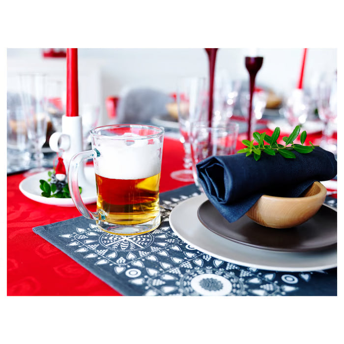 IKEA MJÖD beer tankard on a red tablecloth table setting with plates and green plants