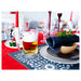 IKEA MJÖD beer tankard on a red tablecloth table setting with plates and green plants