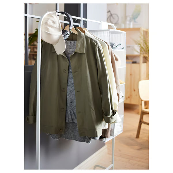  IKEA MULIG white garment rack with jacket, sweater, and cap hanging beside a mirror