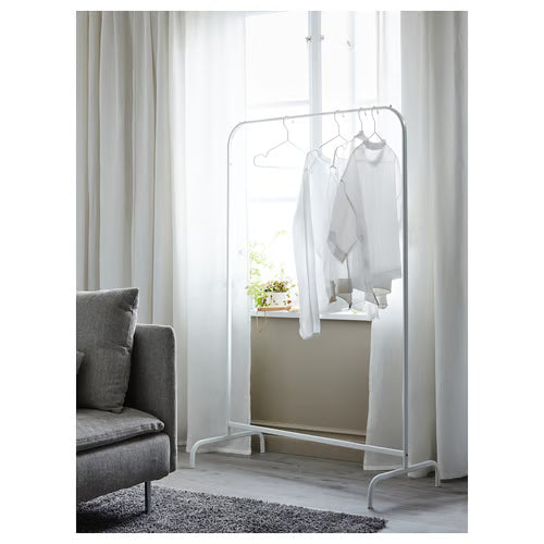 IKEA MULIG white clothes rack in minimalist bedroom setting with armchair and wooden floor