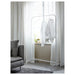 IKEA MULIG white clothes rack in minimalist bedroom setting with armchair and wooden floor
