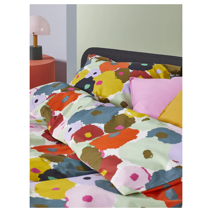 IKEA MURREVA duvet cover styled on a bed in a bright bedroom with coordinating cushions