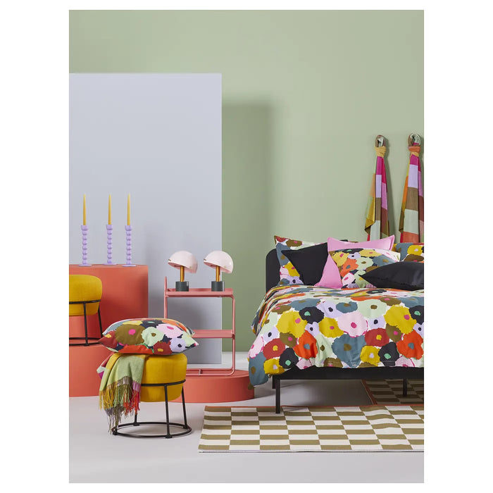 IKEA MURREVA duvet cover styled on a bed in a bright bedroom with coordinating cushions