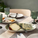 The IKEA NÄBBFISK serving plate displayed on a dining table.80571557 