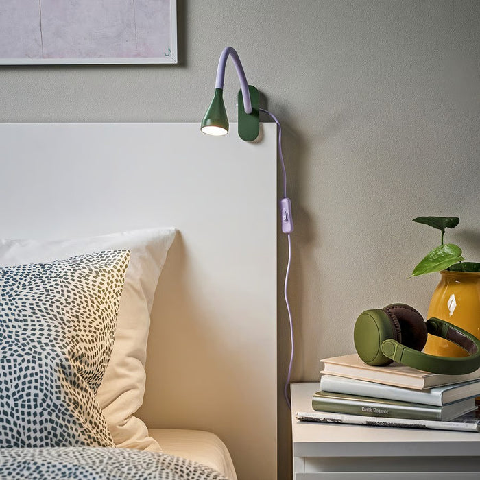 A compact, energy-efficient LED clamp spotlight from IKEA’s NÄVLINGE series, featuring a lilac base and dark green shade. Adjustable head for focused lighting on desks or shelves.